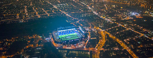 Aerial photo at night over illuminated Stamford Bridge